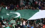 pakistani fans holding a large flag cheer during the match photo by ap
