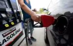 a customer readies to pump gas ap photo