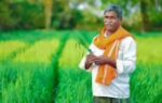 a farmer standing in the field file photo