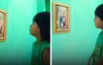 in the viral video a little girl is seen standing in front of a picture of her late father