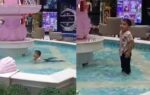 kid playing in fountain