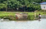 people wade through a flood affected area