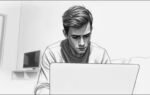 melancholy young man at laptop