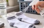 spraying vinegar on socks