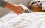 spraying white vinegar on towels