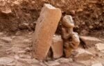 statue of a human sitting on a leopard 1536x864