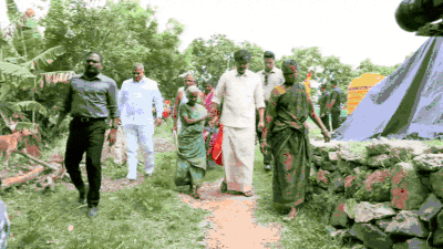 cm vijay gifts sunglasses to an elderly woman