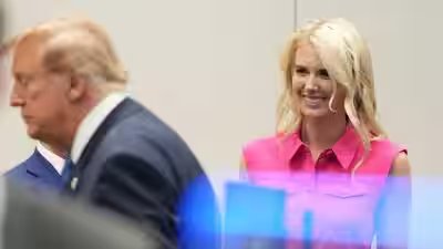 white house aide natalie harp right looks after president donald trump left ap photo