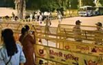 security personnel stand guard near barricades at janpath ahead of the oct 10 protest